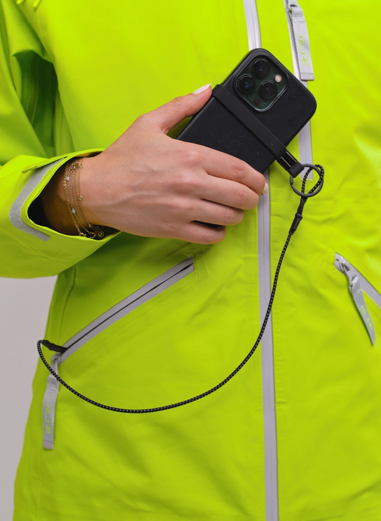 womens bright green shell ski jacket with phone leash